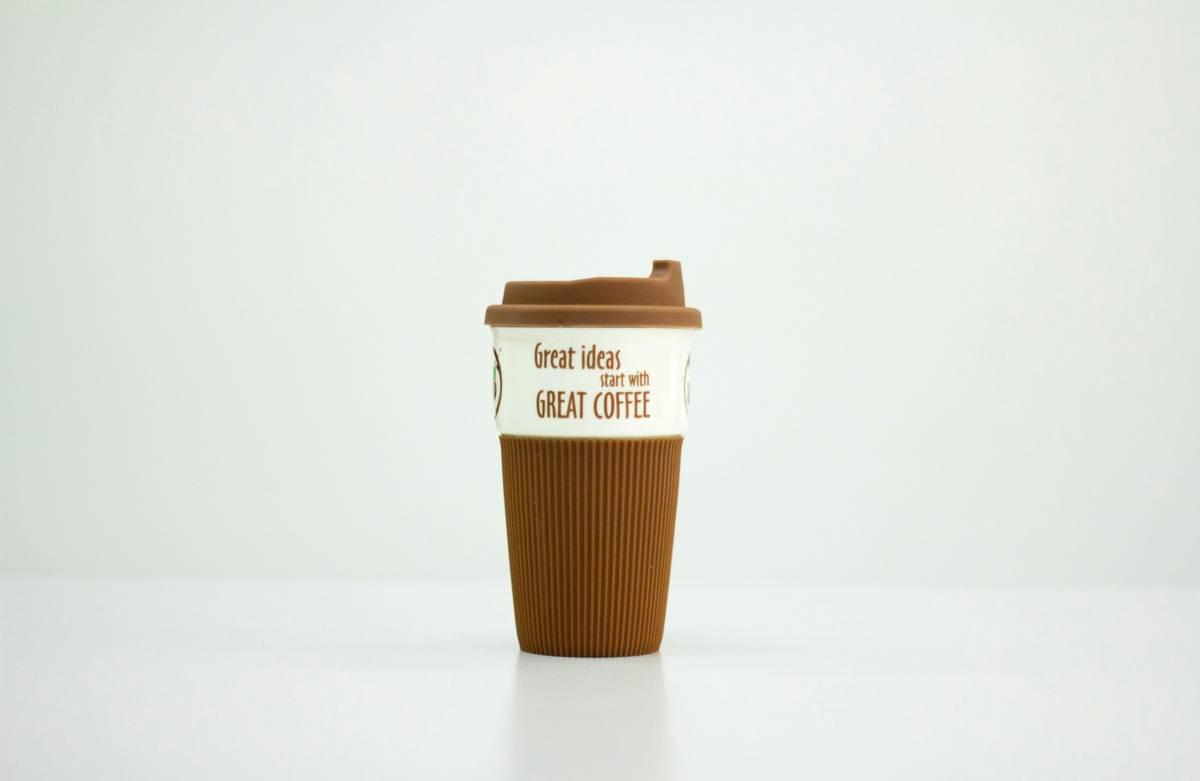Side-by-side comparison showing an earth friendly coffee mug next to disposable cups with landfill waste