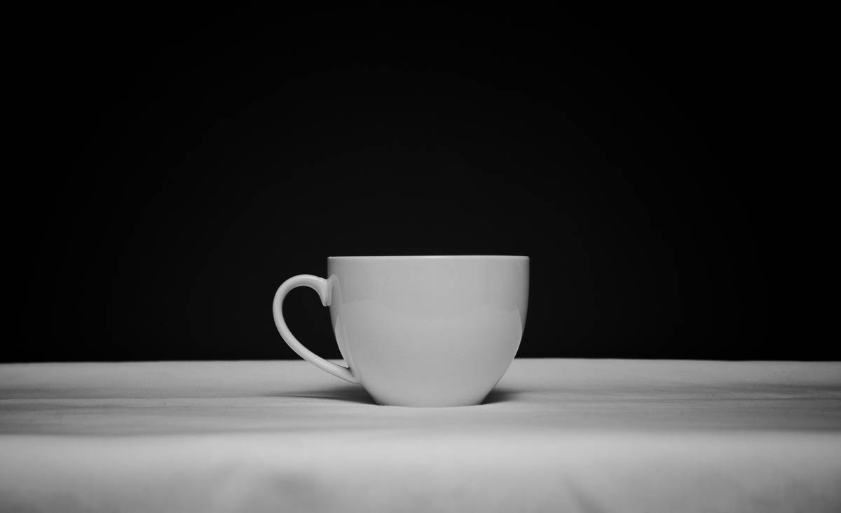 zero foxtrot coffee mug being hand-washed in a kitchen sink showing its seamless interior and threaded lid design